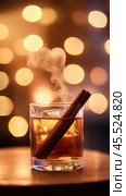 Warm ambiance with spicy rum and cinnamon stick in festive setting. Стоковое AI-изображение, AI-художник Sabyna75 / Фотобанк Лори