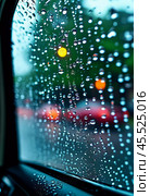 Raindrops cling to the surface of car glass, distorting a vibrant cityscape at evening, where colorful lights from traffic and buildings merge into a beautiful display. Generative AI. Стоковое AI-изображение, AI-художник Юлия Петровская / Фотобанк Лори