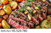 Sizzling grilled steak with roasted potatoes, carrots, and aromatic herbs. Стоковое AI-изображение, AI-художник Юрий Поздников / Фотобанк Лори
