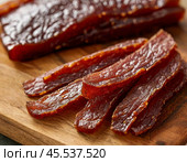 Every year on November 27th, Dried Meat Day is celebrated. The holiday is dedicated to homemade dried meat and simple recipes, the best from generation to generation. Стоковое AI-изображение, AI-художник Сергей Елизарьев / Фотобанк Лори