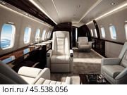 Luxury white interior vip comfortable private jet with laptop on table, at highest. Modern business airplane, perfect decor. Passenger service quality in aviation industry concept. Copy ad text space. Стоковое AI-изображение, AI-художник Aleksandr Golubev / Фотобанк Лори