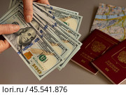 Бумажные деньги доллары, заграничный паспорт, карта государства. Стоковое фото, фотограф Оксана Шведкова / Фотобанк Лори