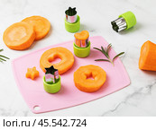 Figured press knives and vegetables on a table. Стоковое фото, фотограф Сергей Чайко / Фотобанк Лори