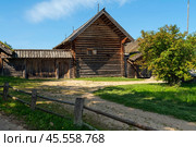 View of an ancient log building on the territory of the Pushkin village in Bugrovo of the Pushkin Museum-Reserve on a sunny summer day, Pushkinskiye Gory, Pskov region, Russia. Редакционное фото, фотограф Ula Ulachka / Фотобанк Лори