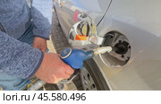 Refueling the car at a gas station fuel pump. Man driver hand refilling and pumping gasoline oil the car with fuel at he refuel station. Car refueling on petrol station. Fuel pump at station. Стоковое видео, видеограф Ирина Михайличенко / Фотобанк Лори