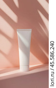 Minimalist mockup of unbranded baby cream tube on soft pink background for cosmetic design. Стоковое AI-изображение, AI-художник Sabyna75 / Фотобанк Лори
