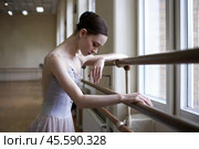 Tired ballerina leaned against a ballet barre near the window. Стоковое AI-изображение, AI-художник Дмитрий Киселёв / Фотобанк Лори