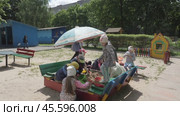 Children, boys and girls in kindergarten play in sand with toys on the street. Kids on playground in sandbox on sunny day: Gomel, Belarus - June 2021. Редакционное видео, видеограф Дмитрий Нечаев / Фотобанк Лори