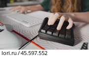 Close-up on hands of girl gamer playing in video game using keyboard and keypad, on table in the frame are gamer accessories. Young woman in cozy home office. Стоковое видео, видеограф Енваев Андрей / Фотобанк Лори