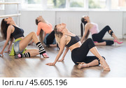 Female dancer mastering floorwork during high heels dance routine. Стоковое фото, фотограф Яков Филимонов / Фотобанк Лори
