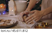 Large piece of dough with cocoa and chocolate is kneaded by baker using their hands in kitchen decorated for Christmas and New Year. Стоковое видео, видеограф Strunov David / Фотобанк Лори