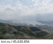 Panoramic view of Novorossiysk City and Tsemess Bay at sunrise. Morning cityscape of large port at Black Sea coast in Russia (2024 год). Стоковое фото, фотограф Фотограф / Фотобанк Лори