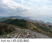 Panoramic view of Novorossiysk City and Tsemess Bay at sunrise. Morning cityscape of large port at Black Sea coast in Russia (2024 год). Стоковое фото, фотограф Фотограф / Фотобанк Лори