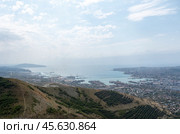 Panoramic view of Novorossiysk City and Tsemess Bay at sunrise. Morning cityscape of large port at Black Sea coast in Russia (2024 год). Стоковое фото, фотограф Фотограф / Фотобанк Лори