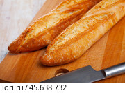 French loaves on wooden surface. Стоковое фото, фотограф Яков Филимонов / Фотобанк Лори