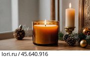 A mock-up of a cozy burning candle made of amber glass with an empty white label in a festive, New Year's home interior. Стоковое AI-изображение, AI-художник Photojuli / Фотобанк Лори