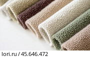 Boucle Fabric samples in various neutral colors close up arranged, texture detail, interior design palette background. Стоковое AI-изображение, AI-художник Анастасия Золотницкая / Фотобанк Лори