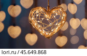 The concept of Valentine's Day, a banner with garlands in the form of hearts and magic lights for a holiday filled with love. A place for the text. Стоковое AI-изображение, AI-художник Photojuli / Фотобанк Лори
