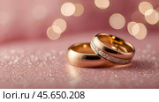 Gold wedding rings on a pink background with a side. Wedding rings. The wedding day. The newlyweds. Стоковое AI-изображение, AI-художник Photojuli / Фотобанк Лори