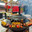 Holiday fair on the street in winter in the city. Cooking vegetables on the grill at the festivities (2024 год). Редакционное фото, фотограф Zima Nadezhda / Фотобанк Лори