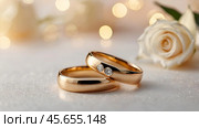 Gold wedding rings on a white background with a side. Wedding rings. The wedding day. The newlyweds. Стоковое AI-изображение, AI-художник Photojuli / Фотобанк Лори