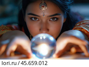 Gypsy fortune teller peers into a glass ball. Стоковое AI-изображение, AI-художник Евгений Харитонов / Фотобанк Лори