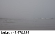 Gradually enveloping fog softly covers an empty beach. Стоковое видео, видеограф Данил Руденко / Фотобанк Лори