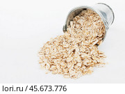 Oat flakes  spilling out of bucket. Стоковое фото, фотограф Александр Собко / Фотобанк Лори