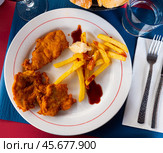 Crisp chicken nuggets with golden brown crust and french fries. Стоковое фото, фотограф Яков Филимонов / Фотобанк Лори