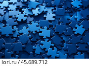 Blue puzzle pieces forming a complex and intriguing background design. Стоковое AI-изображение, AI-художник Иван Рябоконь / Фотобанк Лори