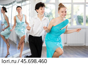 Motivated couple of teen dancers practicing vigorous Lindy Hop. Стоковое фото, фотограф Яков Филимонов / Фотобанк Лори