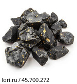 Pile of black tourmaline rough stones with gold inclusions. Стоковое AI-изображение, AI-художник Иван Рябоконь / Фотобанк Лори