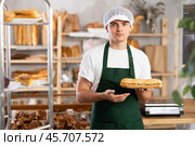 Smiling young bakery seller offering traditional Spanish bocadillo. Стоковое фото, фотограф Яков Филимонов / Фотобанк Лори