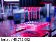 Laboratory robot dispensing red chemical liquid into microplate using automatic pipettes. Стоковое AI-изображение, AI-художник Иван Рябоконь / Фотобанк Лори