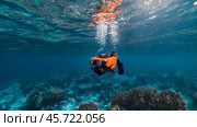 Underwater exploration using a remote-operated submersible in a vibrant coral reef. Стоковое AI-изображение, AI-художник Сергей Толмачёв / Фотобанк Лори