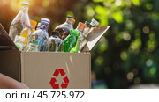 Cropped unrecognized person carrying crate of empty plastic bottles. Recycling plastic concept. Hands with Recycle Bin. Littering of environment. Problem of global plastics pollution of the Earth. Стоковое AI-видео, аниматор Марина Демидюк / Фотобанк Лори