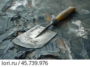 Used putty knife resting on scraped paint surface during home renovation. Стоковое AI-изображение, AI-художник Иван Рябоконь / Фотобанк Лори