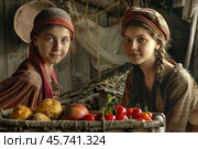 Two young peasant girls showing fresh produce from their farm. Стоковое AI-изображение, AI-художник Иван Рябоконь / Фотобанк Лори
