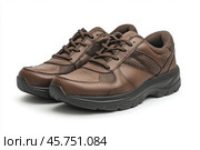 Dark brown leather lace-up running shoes with low tops, thick soles. The laces and black rubber outsole. Sporty look. Men to wear during outdoor activities, hiking. Brown shoes. Trendy Male Boots Pair. Стоковое AI-изображение, AI-художник Марина Демидюк / Фотобанк Лори