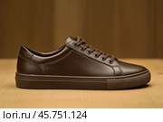 Dark brown leather lace-up running shoes with low tops, thick soles. The laces and black rubber outsole. Sporty look. Men to wear during outdoor activities, hiking. Brown shoes. Trendy Male Boot Side. Стоковое AI-изображение, AI-художник Марина Демидюк / Фотобанк Лори