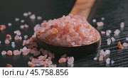 Himalayan pink salt in a wooden is used to flavor food. Due mainly to marketing costs, pink Himalayan salt is up to twenty times more expensive than table or sea salt. Стоковое видео, видеограф Андрей Армягов / Фотобанк Лори