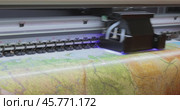 Modern Digital Large format UV printer. Printing production technologies. UV pinning is the process of applying a dose of low intensity ultraviolet light to a UV curable ink. Стоковое видео, видеограф Андрей Армягов / Фотобанк Лори