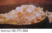 Himalayan pink salt in a wooden is used to flavor food. Due mainly to marketing costs, pink Himalayan salt is up to twenty times more expensive than table or sea salt. Стоковое видео, видеограф Андрей Армягов / Фотобанк Лори