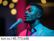 Performer stands near microphone under colorful lights at evening event. Стоковое AI-изображение, AI-художник Юлия Гапеенко / Фотобанк Лори