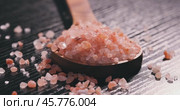 Himalayan pink salt in a wooden is used to flavor food. Due mainly to marketing costs, pink Himalayan salt is up to twenty times more expensive than table or sea salt. Стоковое видео, видеограф Андрей Армягов / Фотобанк Лори