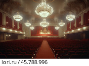 Elegant theater interior showcasing chandeliers and plush seating in a grand setting. Стоковое AI-изображение, AI-художник Юлия Гапеенко / Фотобанк Лори