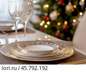 Christmas dining table, Christmas tree background. Стоковое AI-изображение, AI-художник Римма Тельнова / Фотобанк Лори