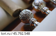 Elegant silver wax seal handles resting on wooden box. Стоковое видео, видеограф Данил Руденко / Фотобанк Лори