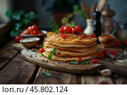 Стопка несладких блинов с помидорами черри и зеленью на деревенском деревянном столе. Стоковое AI-изображение, AI-художник Anna Leeva / Фотобанк Лори