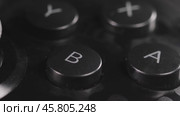 Modern gamepad on a dark. Game controller close-up. Стоковое видео, видеограф Андрей Армягов / Фотобанк Лори